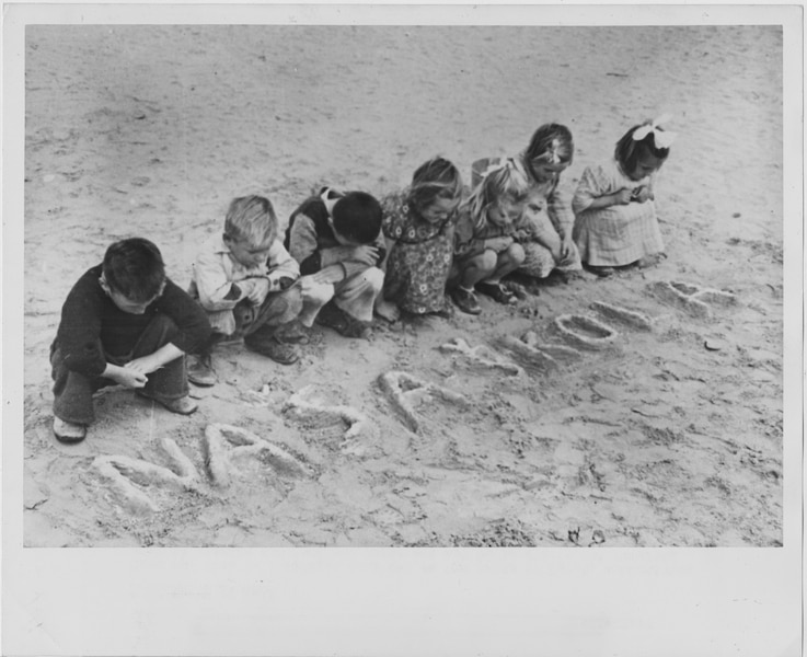 Croatian children wrote the words for "our school" in the sand of the Tolumbat camp in 1945.
