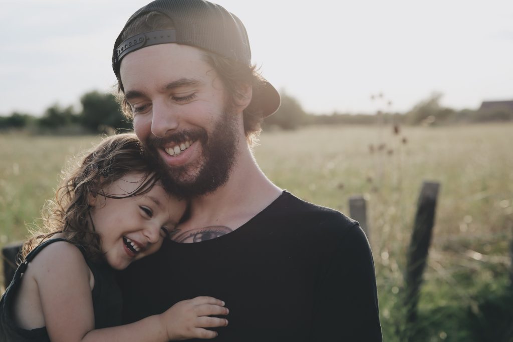 usa 4-day-week: A father holds his daughter on his arms 